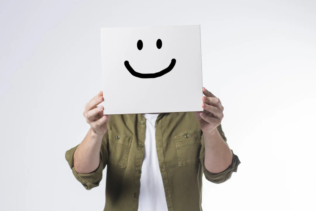 A person smiling while connecting with friends in a park